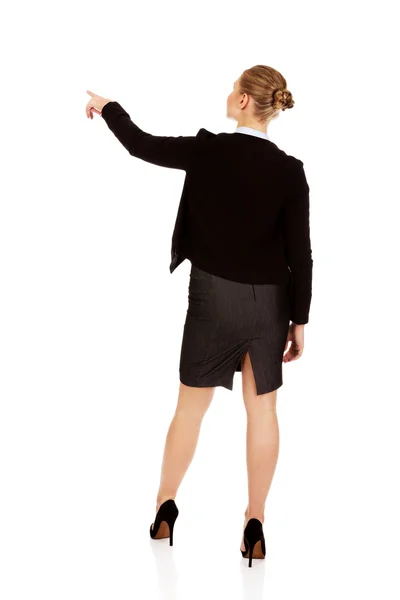 Back view of young business  woman pointing for somathing — Stock Photo, Image