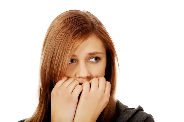 Stressed teenage woman biting nails — Stock Photo, Image