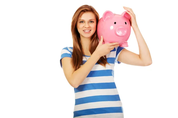 Happy teenage woman holding piggybank — Stock Photo, Image