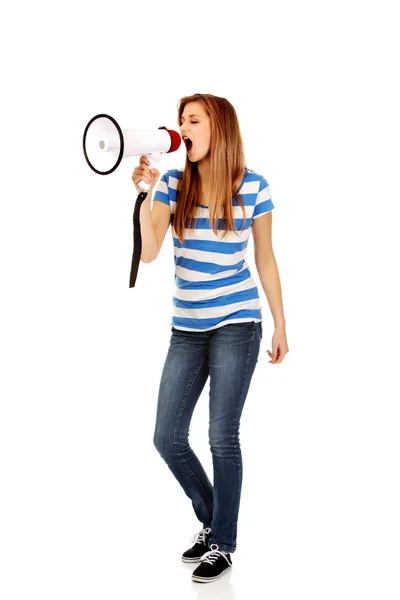 Teenage woman screaming through megaphone — Stock Photo, Image