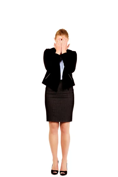 Troubled business woman covering her face with hands Royalty Free Stock Images