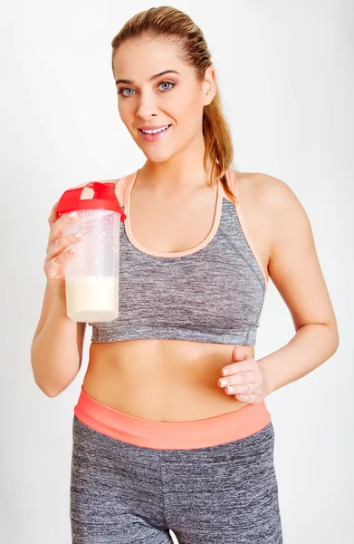 Young sporty woman with protein shake bottle — Stock Photo, Image