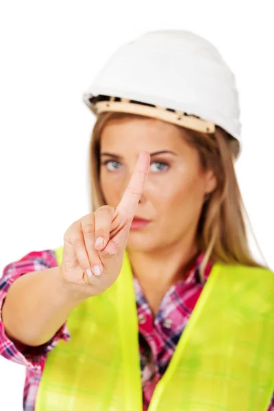 Female builder shows one finger — Stock Photo, Image