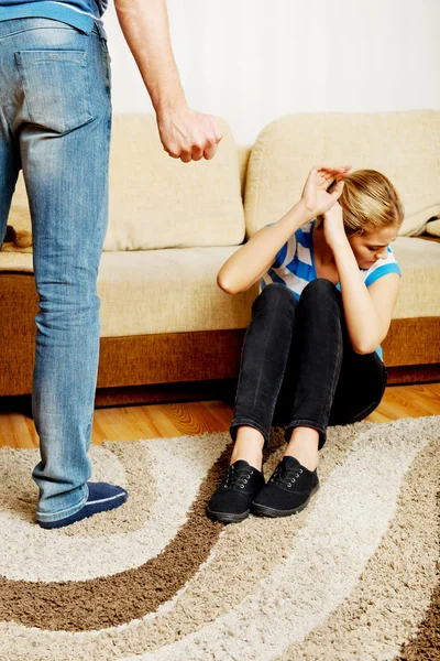 Woman trying to hide herself, man want to hit her with fist — Stock Photo, Image