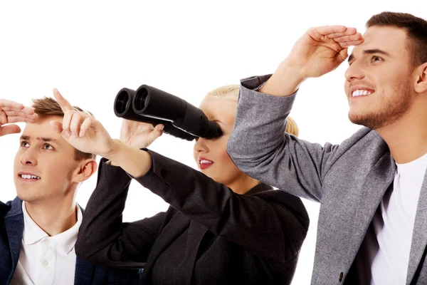 Business team looking into one direction-woman using binoculars — Stock Photo, Image