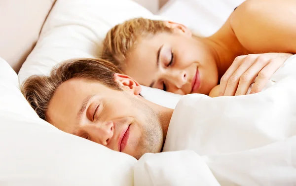 Młoda para śpi w łóżku — Zdjęcie stockowe