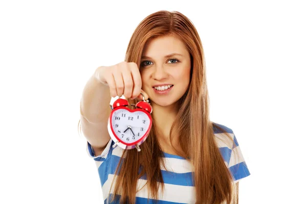 Teenage woman holding alarm clock — Stock Photo, Image