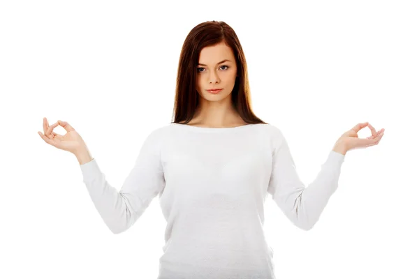Young woman makes meditating gesture — Stock Photo, Image
