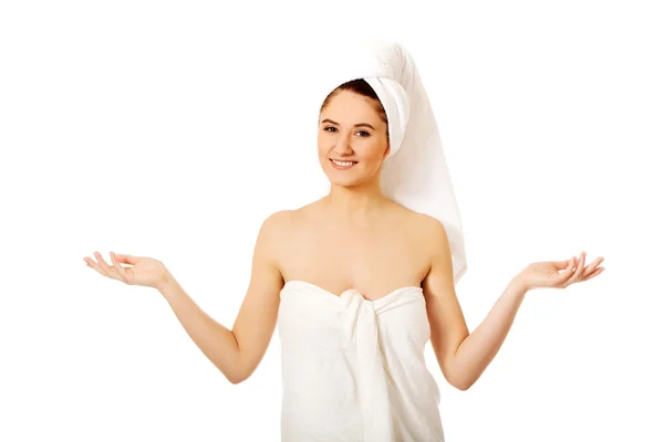 Spa woman wrapped in towel showing copyspace in hands — Stock Photo, Image