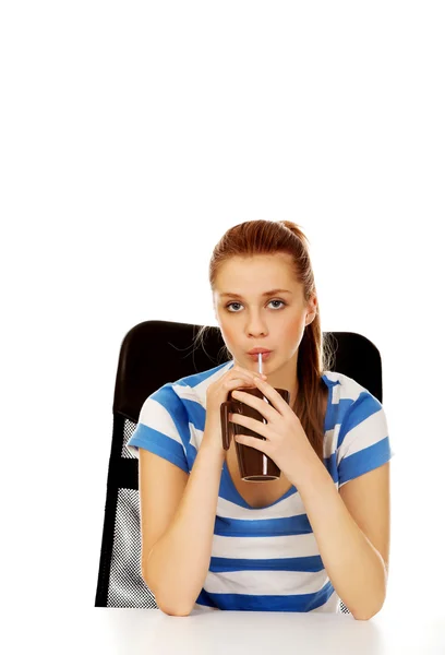 Teenage woman drinking something through straw — Stock Photo, Image