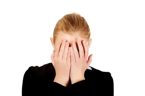 Troubled business woman covering her face with hands — Stock Photo, Image