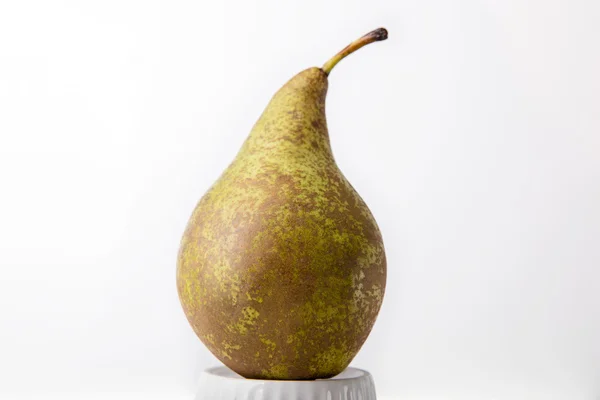 Ripe pear on the porcelain form — Stock Photo, Image