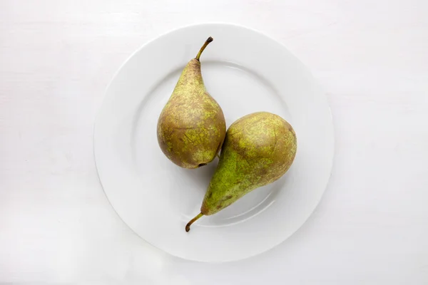 Two pears on white plate — Stock Photo, Image