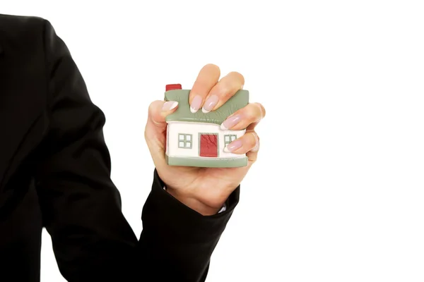 Model house is crushed in the woman hand — Stock Photo, Image