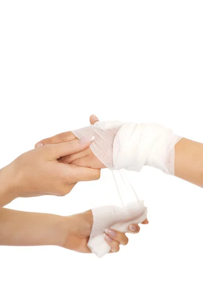 Female doctor bandaging woman hand — Stock Photo, Image