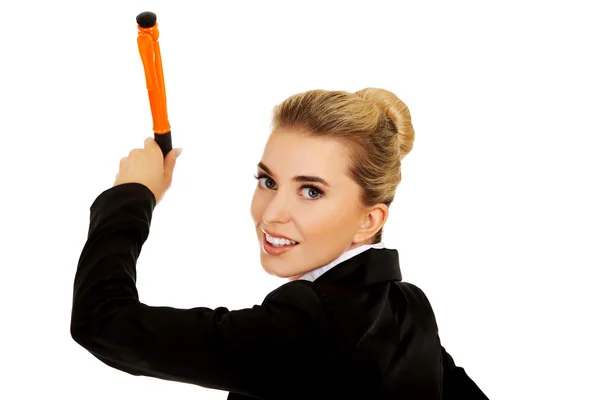 Young businesswoman writes something with big pen — Stock Photo, Image