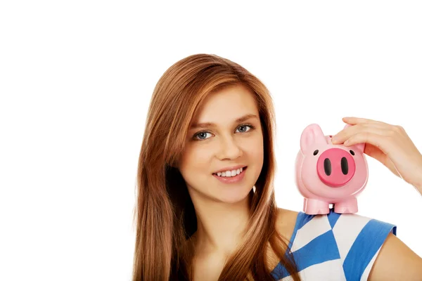 Happy teenage woman holding piggybank — Stock Photo, Image