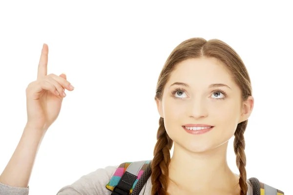 Schoolgirl pointing up. — Stock Photo, Image