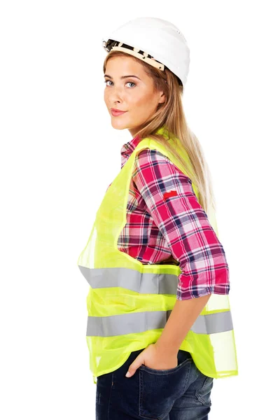 Mujer constructora sonriente cogida de la mano en el bolsillo —  Fotos de Stock