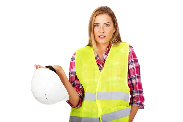 Angry female builder holding helmet — Stock Photo, Image