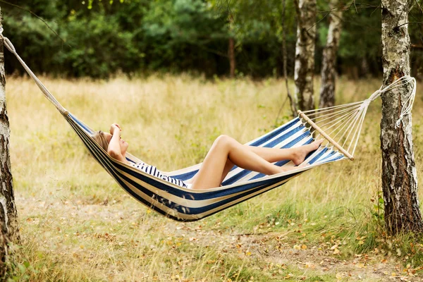 Young blonde woman resting on hammock — Stock Photo, Image