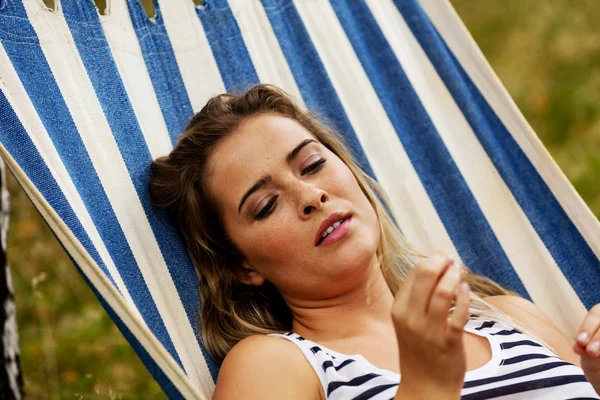 Young blonde woman resting on hammock — Stock Photo, Image