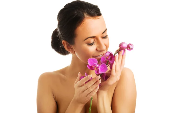 Topless woman with purple orchid branch — Stock Photo, Image