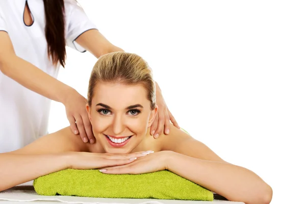 Young smile woman lying on a massage table and has massage. — Stock Photo, Image