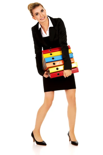 Young businesswoman carries heavy binders — Stock Photo, Image