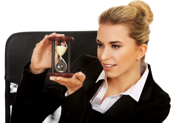 Молодая предпринимательница держит песочные часы — стоковое фото