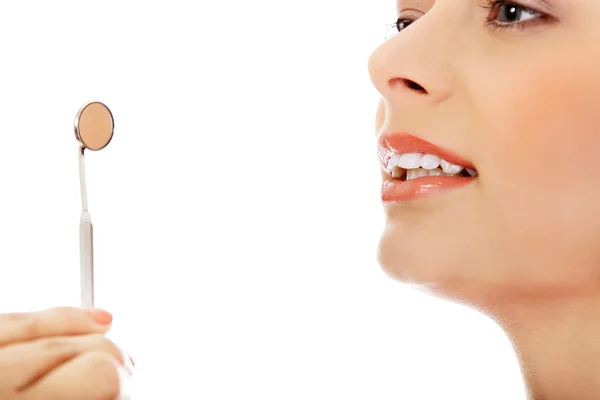 Young woman teeth and a dentist mouth mirror — Stock Photo, Image