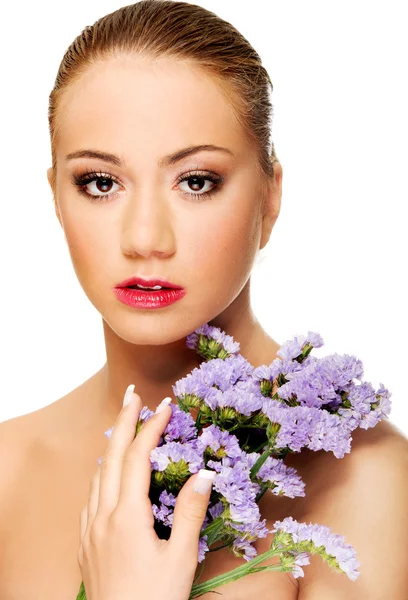 Sensual young spa woman holding flower. — Stock Photo, Image