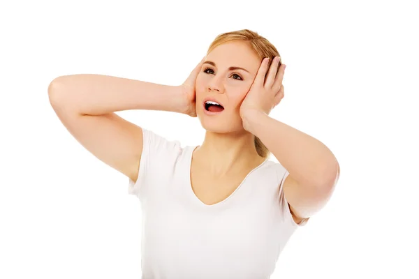 Jeune femme en colère couvrant les oreilles avec les mains — Photo