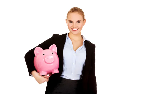 Joven mujer de negocios sosteniendo Piggybank —  Fotos de Stock