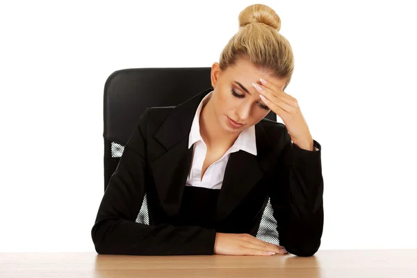 Beautiful worried businesswoman behind the desk — Stock Photo, Image