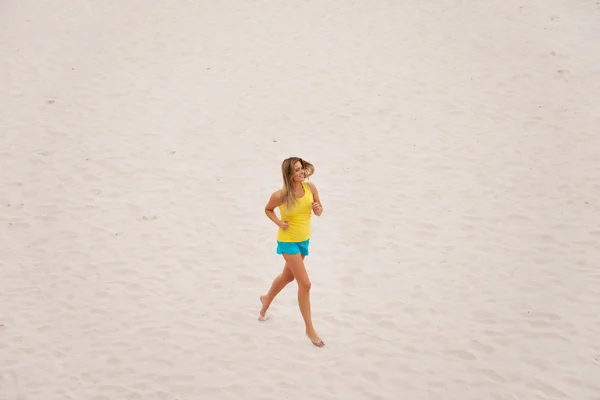 Giovane donna che corre sulla spiaggia — Foto Stock