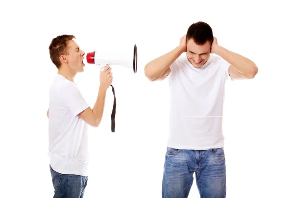 Young man shouting into a megaphone — Stock Photo, Image