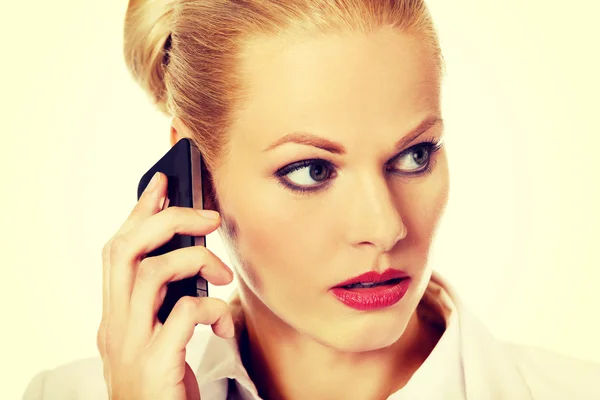 Mujer de negocios seria hablando a través de un teléfono móvil — Foto de Stock