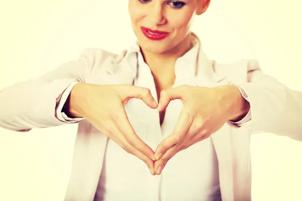 Business woman making a heart shape with her hands — Stock Photo, Image