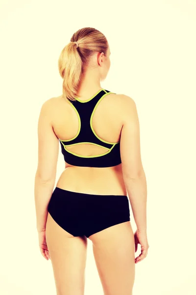 Rückenansicht einer jungen athletischen Frau in Sportunterwäsche — Stockfoto