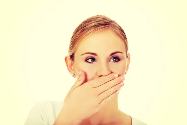 Young woman covering her mouth with hand Royalty Free Stock Photos