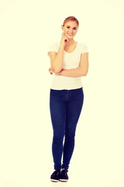 Young  woman with folded hands and finger on cheek — Stock Photo, Image