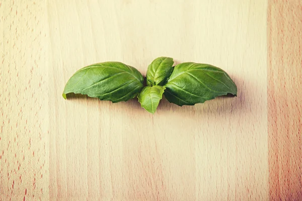 Leaf of basil on wooden background — Stock Photo, Image