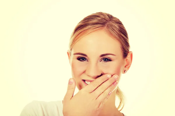 Young woman giggles covering her mouth with hand — Stock Photo, Image