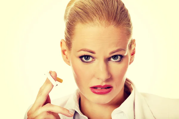 Business woman holding broken cigarette — Stock Photo, Image