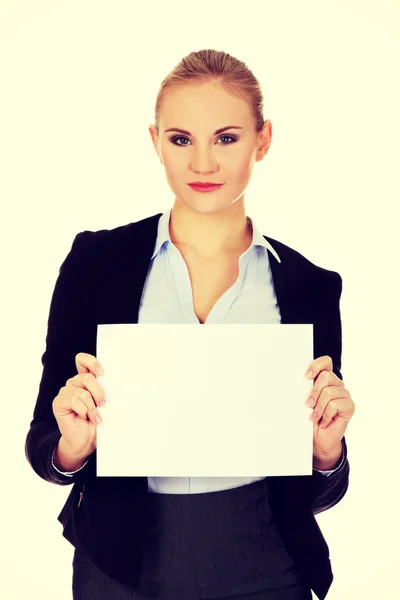 Smiling young businesswoman holding blank banner — Stock Photo, Image