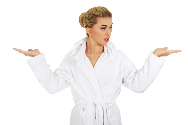 Young surprised woman after bath holding something — Stock Photo, Image