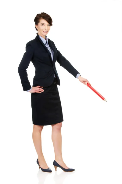 Businesswoman pointing down with pencil. — Stock Photo, Image