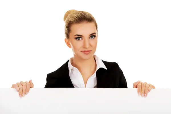 Mujer de negocios sonriente sosteniendo banner vacío —  Fotos de Stock