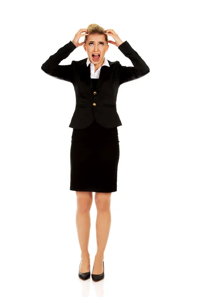 Angry businesswoman pulling her hair and screaming — Stock Photo, Image